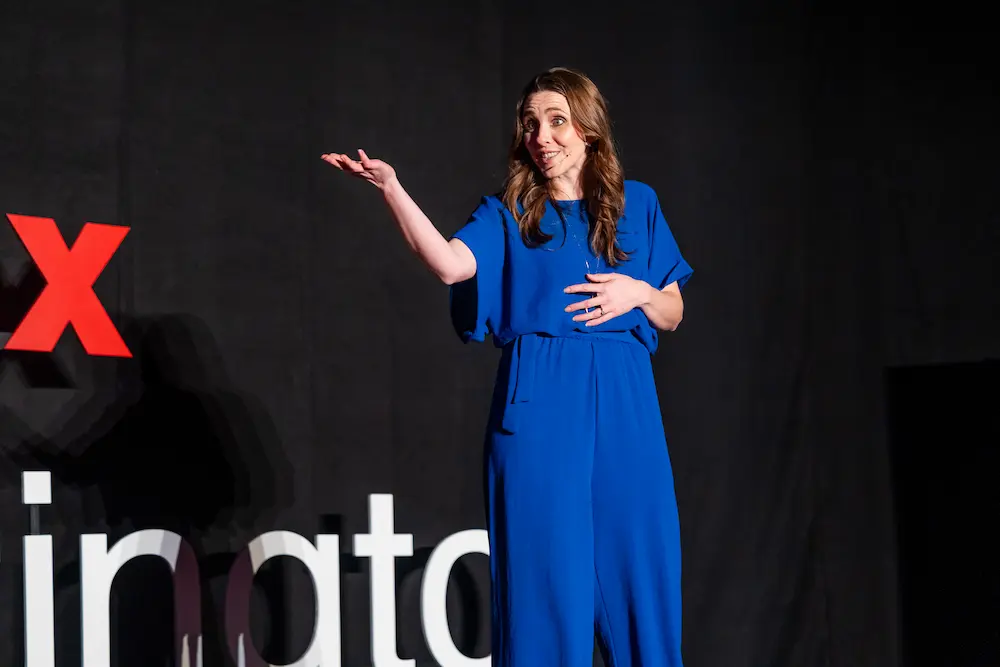 Dr Jess Morgan speaking on stage at TEDxWarrington
