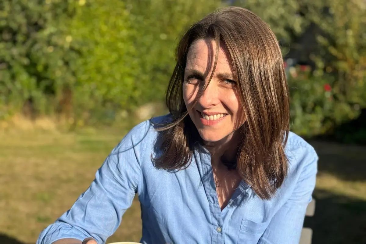 Dr Jess Morgan smiling outdoors in a garden setting