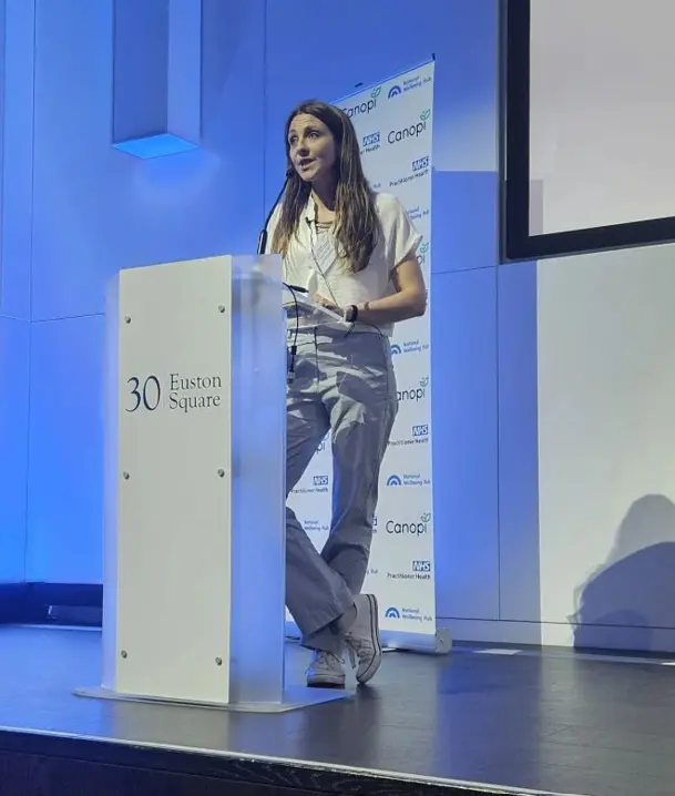Dr Jess Morgan speaking at a podium